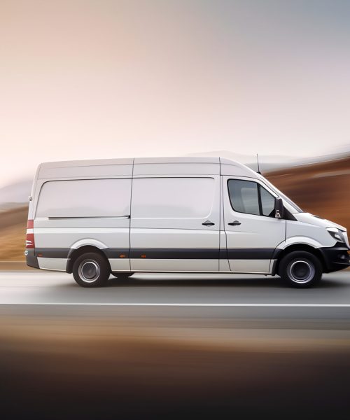 white-van-driving-down-road-with-word-ford-side